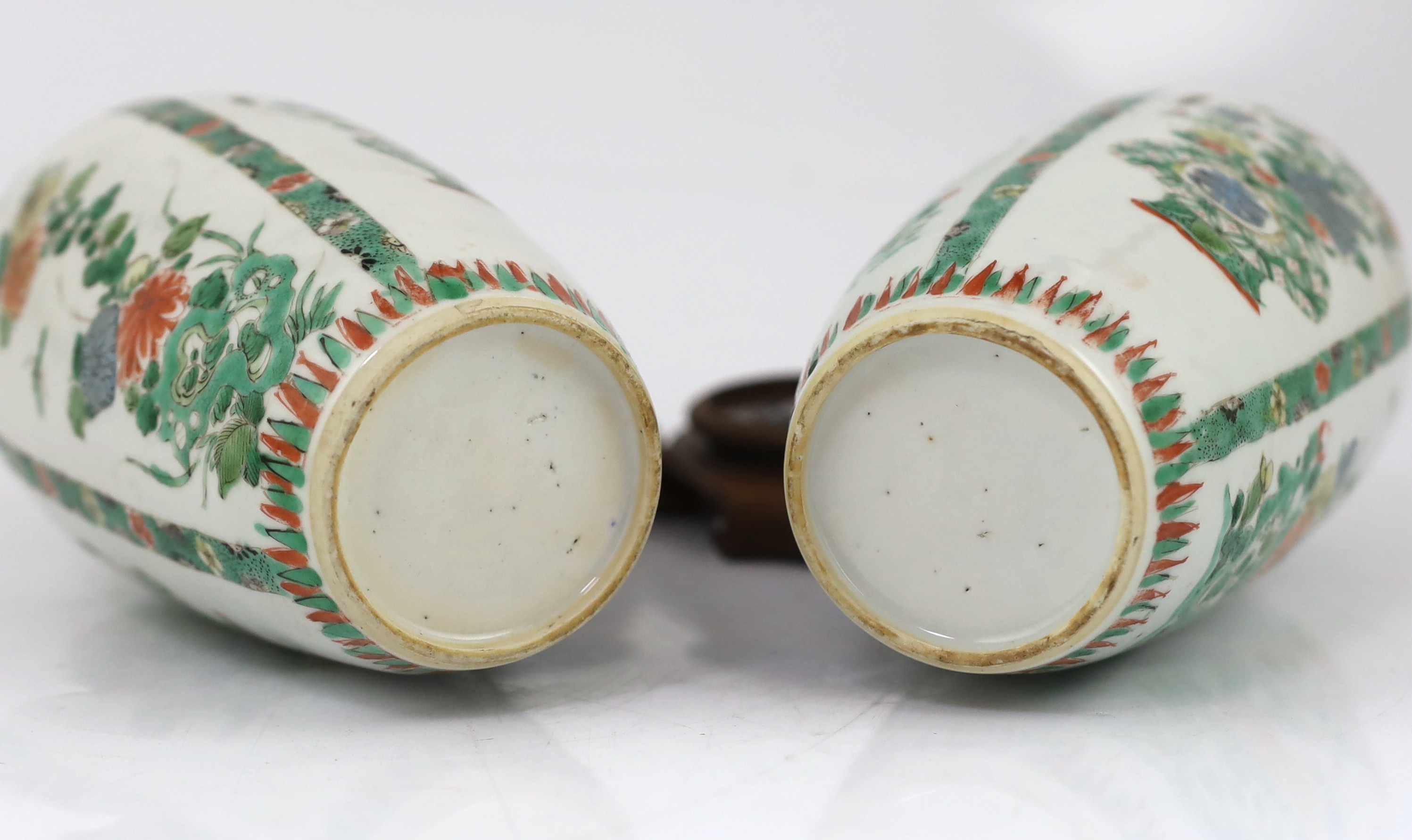 A near pair of Chinese famille verte jars, Kangxi period, on wood plinths, blue enamels repainted